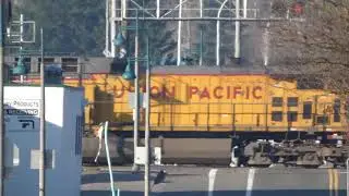 (Southbound) Union Pacific Empty Garbage passes through the West Main Street Railroad Crossing.