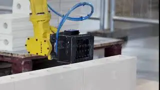 Industrial robot exhibit at work. Media. Bricklayer robot for automated building construction