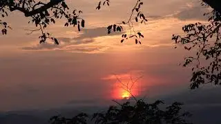 A beautiful sunrise over a mountain and forest.