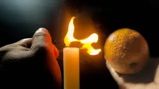 Squeezing Orange Peel near the fire in slow motion
