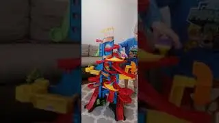 Ostap is playing with the track Little people take turns Skyway from Fisher Price