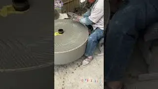 The stonemason hammered the green round grinding stone with a hammer