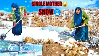 Homeless mother guardsher hut against wintersnow and rain