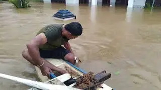 Men rescue stranded dog during severe flooding in Ratnapura, Sri Lanka