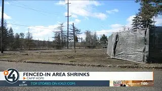 Crews move Camp Hope fencing 45 feet inward