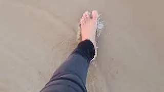 Walking barefoot on wet sand