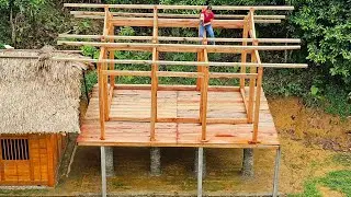 A great idea: The girl successfully assembled a wooden house with a blue corrugated iron roof
