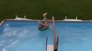 Kid Trying to Balance on a Stick Above a Pool Falls - 1052820