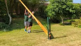 Raising a wooden flagpole into steel tabernacle