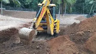 Jcb 3dx digging and gathering soil 