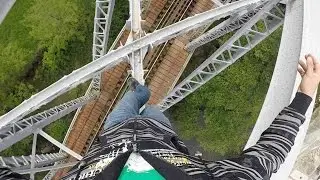 Man Walks On Bridge Poles Above Moving Train