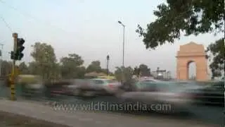 Traffic of Delhi in quick motion with India Gate in back-drop