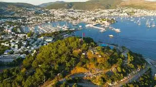 Bodrum, Turkey. Aerial drone view of Tiger Tower on a hill with Turkish flag above Bodrum Bay wit...