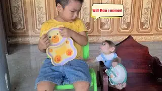 Baby Monkey David holds a bowl and sits in line with his brother waiting for Mom to share the waterm