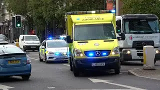 Emergency ambulance and police car make progress through oncoming traffic