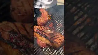 Thick pork chops w/ bone in belly brined in maple brown sugar cherry wood smoked charcoal finished