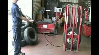Remote inflation of tire in a safety cage per OSHA requirements