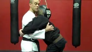 Defense against a Bear Hug ( arms pinned )