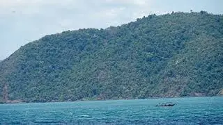 Motorboat navigating near a tropical island in thailand