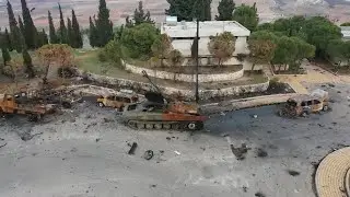 Aftermath of battle in Syrian city of Hama with charred tanks near mosque