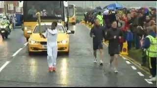 Haile Gebresalassie passes the Olympic Torch to Brendan Foster.