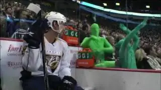 Root Suit fans, green men at hockey game mocking opposition players in full body spandex suits.mp4