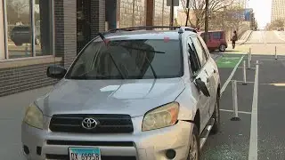 Abandoned SUV on Milwaukee Avenue bike lane damaged