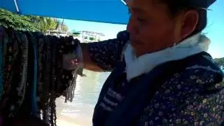 Acapulco - girl walks by with Fried Bananas and kids want to be on camera