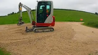 Mini Digger Pushing Stone With The Dozer Blade Takeuchi TB216 Excavator