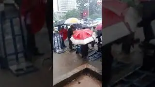 WOMAN TAKING A BATH AT CBD//NAIROBI RAINS