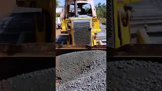 Bulldozer Transforming Dusty Road into Smooth Surface