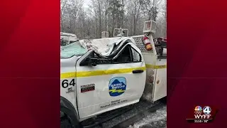 Two linemen escape unharmed after tree falls on truck during ice storm