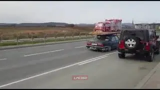 Car drives overloaded with cement bags