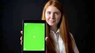 Green Screen woman typing on tablet and showing screen with chromakey