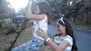 Child's Play. Girls Swing from Vines