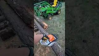 using the brush crusher to hold the log to cut firewood.