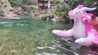 Adventure boys play with pink inflatable dragon