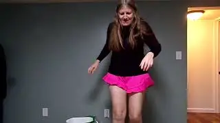 ALICIA AROL mops kitchen floor with her feet while semi dancing to song she loves 'Man On A Mission'