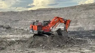 Big diger Hitachi Ex 2600-6 Loading blast material overburden on Dumper Caterpillar ~ miningstory