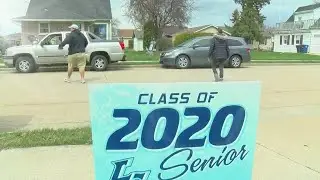 Little Chute school district employees place signs in yards of senior students