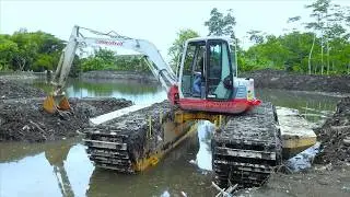 Mini Excavator With Amphibious Floating Track Working On The Small River