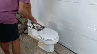 Smashing a one piece toilet with a hammer