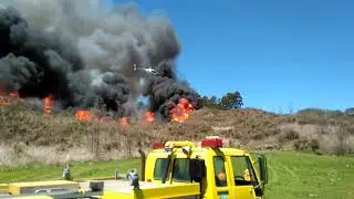 Helicopter dropping napalm, controlled scrub burnoff NZ