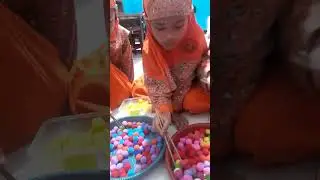 Memindahkan bola bola kecil menggunakan sumpit 