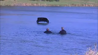car in lake in the hills