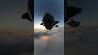 Beautiful sunset wingsuit flight through clouds