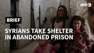 Displaced families seek shelter at abandoned prison in Idlib, Syria | AFP