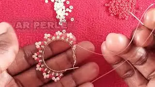 Fabrique tes boucles d’oreilles en perles uniques et raffinées.