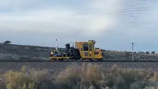 Passing next to group of railroad train track construction maintenance vehicles