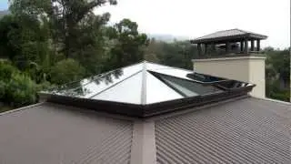 Custom Structural glass pyramid skylight with a flush operable lite.